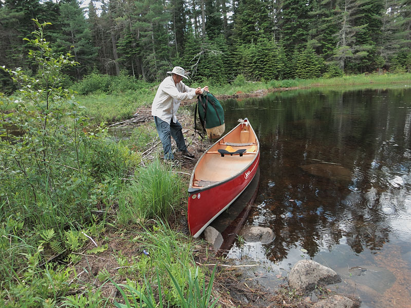 Loading canoe on Carcajou Creek above Wenda Lake in Algonquin Park