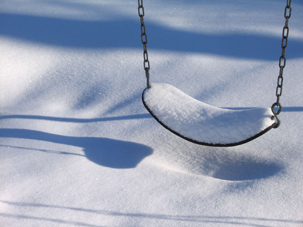 snow covered swing