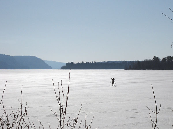 a lone skier on the Ottawa River ice at Deep River