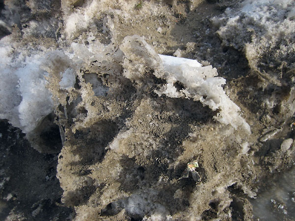 Sun sculpted piles of snow removed from the streets of Deep River
