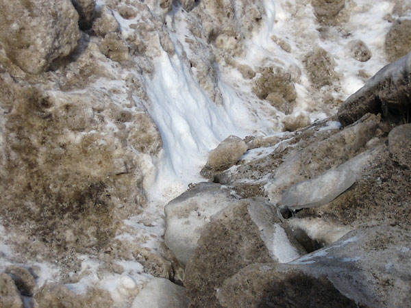 Sun sculpted piles of snow removed from the streets of Deep River