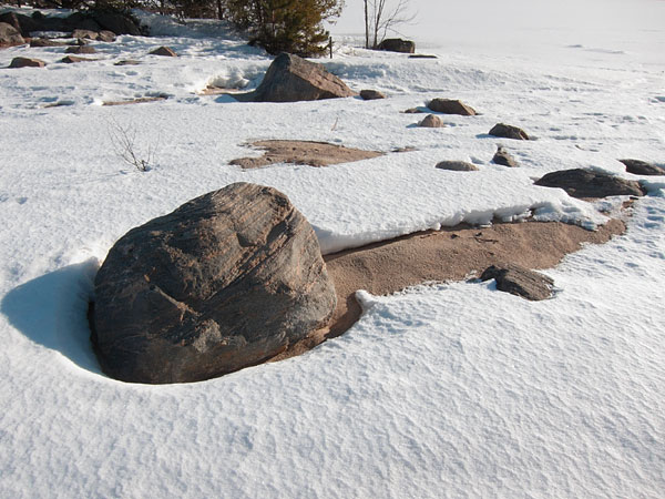 rocks and snow at Pine Point Beach on the Ottawa River at Deep River