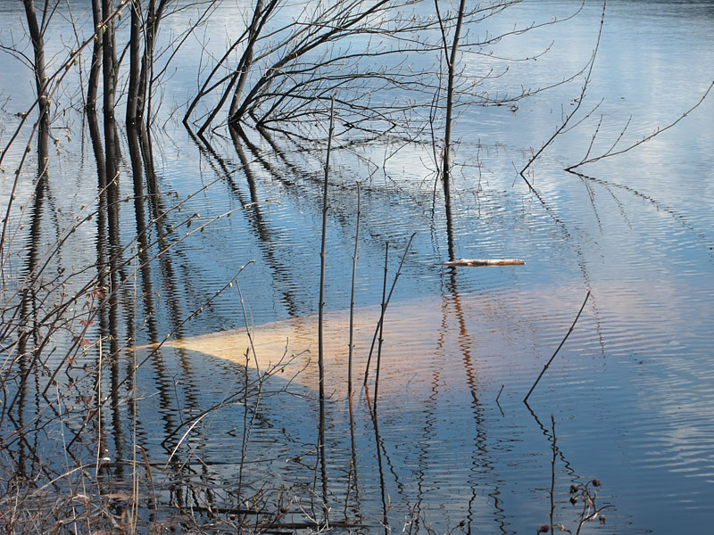 high water and submerged boat along the Deep River waterfront