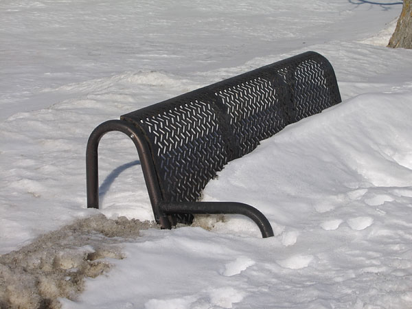 Snow covered bench by the Deep River town hall